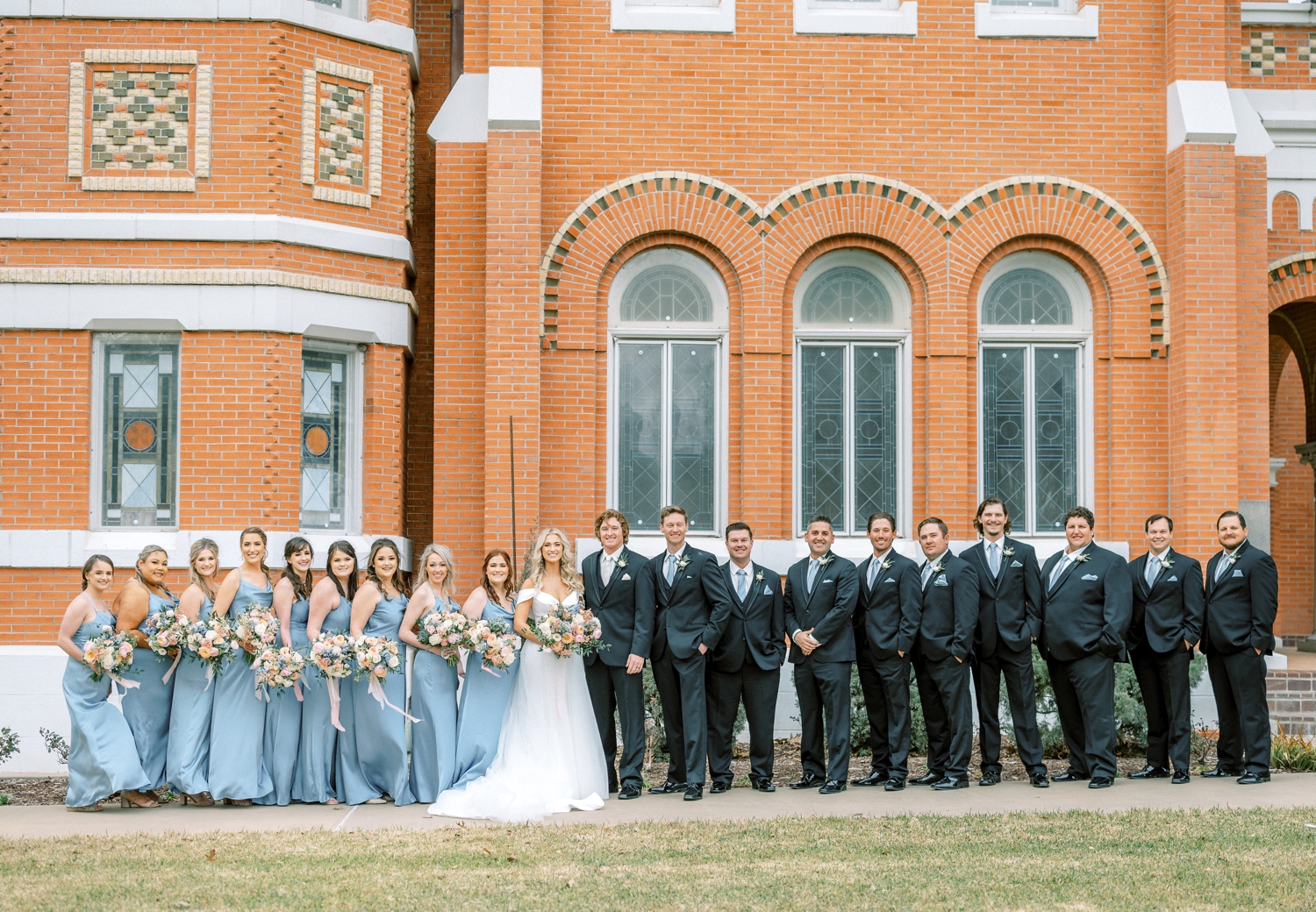 Wedding Party Portraits Outside of Church | Reiley and Rose | Central Texas Floral Designer | Luling, TX Wedding | Western Wedding, pastel wedding, Cinderella wedding inspo, ideas for beauty and the beast wedding, light blue bridesmaid dress, groomsmen suits | via reileyandrose.com