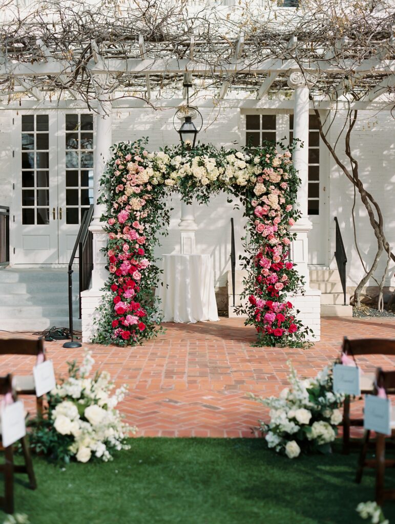 Pink and white ombre ceremony arch for outside wedding at Woodbine Mansion in Austin, TX. | Austin Wedding Floral Designer | Reiley + Rose