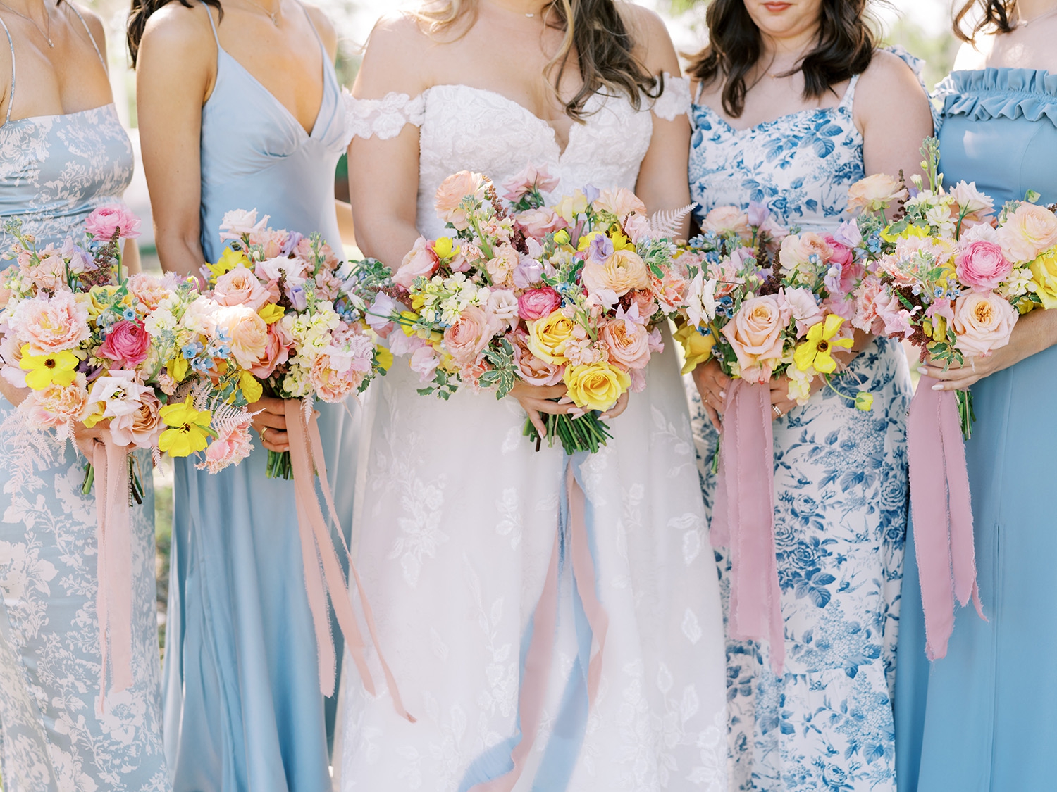 Mismatched bridesmaids dresses with colorful pink and yellow bouquets at Mae's Ridge | Reiley + Rose | Central Texas Floral Designer