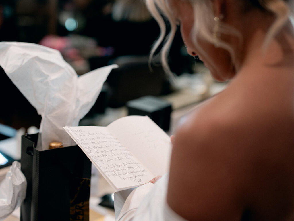 bride reading letter from groom  | Chandelier of Gruene Wedding | Modern Black and White Chic Wedding | 