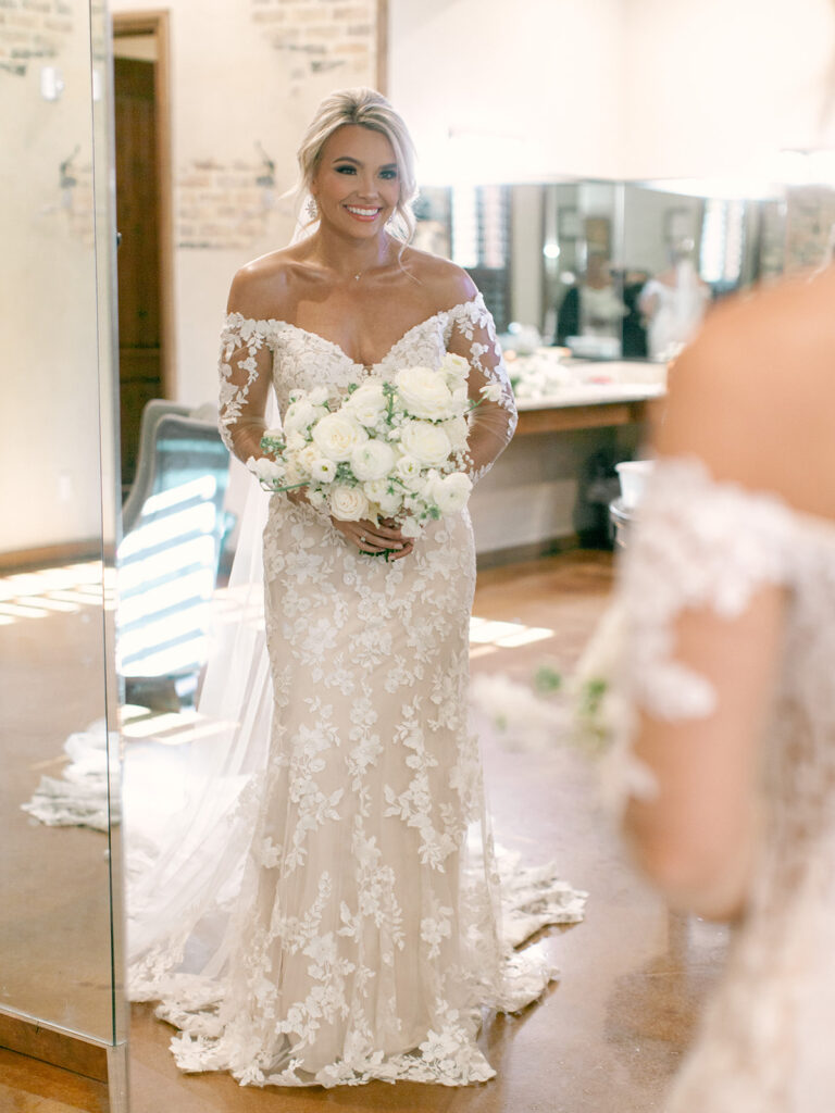 bride looking in mirror  | Chandelier of Gruene Wedding | Modern Black and White Chic Wedding | 