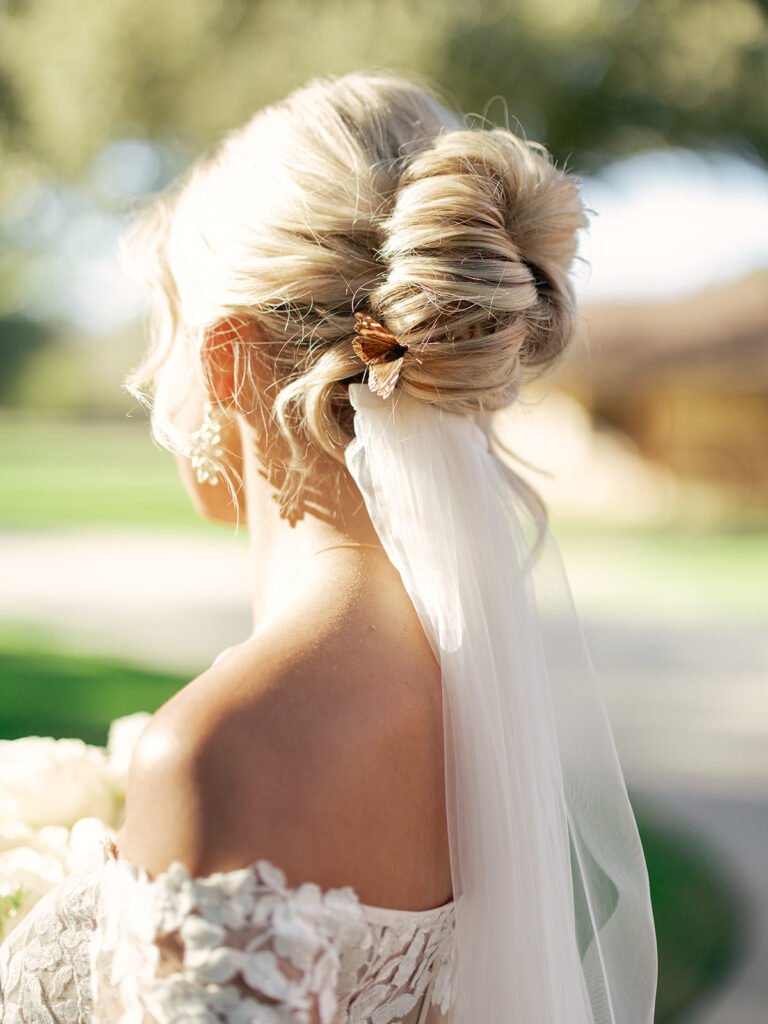 bride with butterfly in her hair  | Chandelier of Gruene Wedding | Modern Black and White Chic Wedding | 