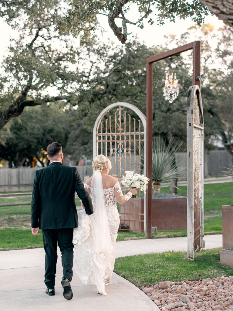 bride and groom arriving to venue | Chandelier of Gruene Wedding | Modern Black and White Chic Wedding | 