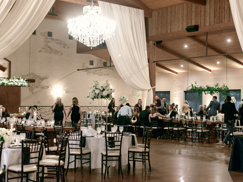 room shot of venue  | Chandelier of Gruene Wedding | Modern Black and White Chic Wedding | 