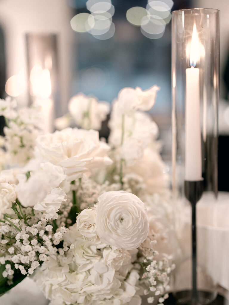 close up of taper candle and floral arrangement | Chandelier of Gruene Wedding | Modern Black and White Chic Wedding | 