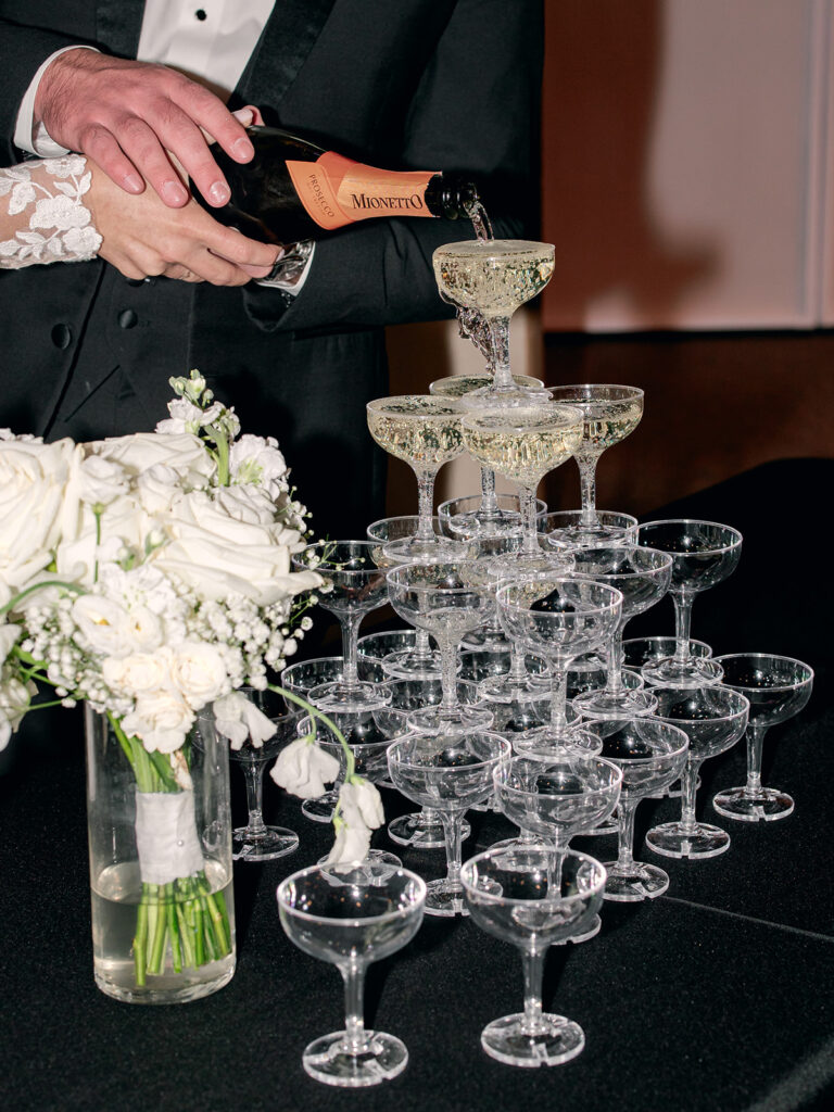 pouring champagne tower  | Chandelier of Gruene Wedding | Modern Black and White Chic Wedding | 