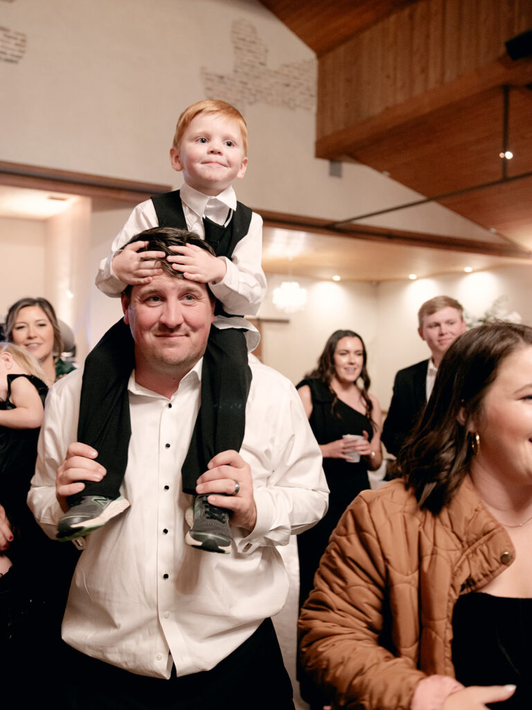 ringbearer on dads shoulders  | Chandelier of Gruene Wedding | Modern Black and White Chic Wedding | 