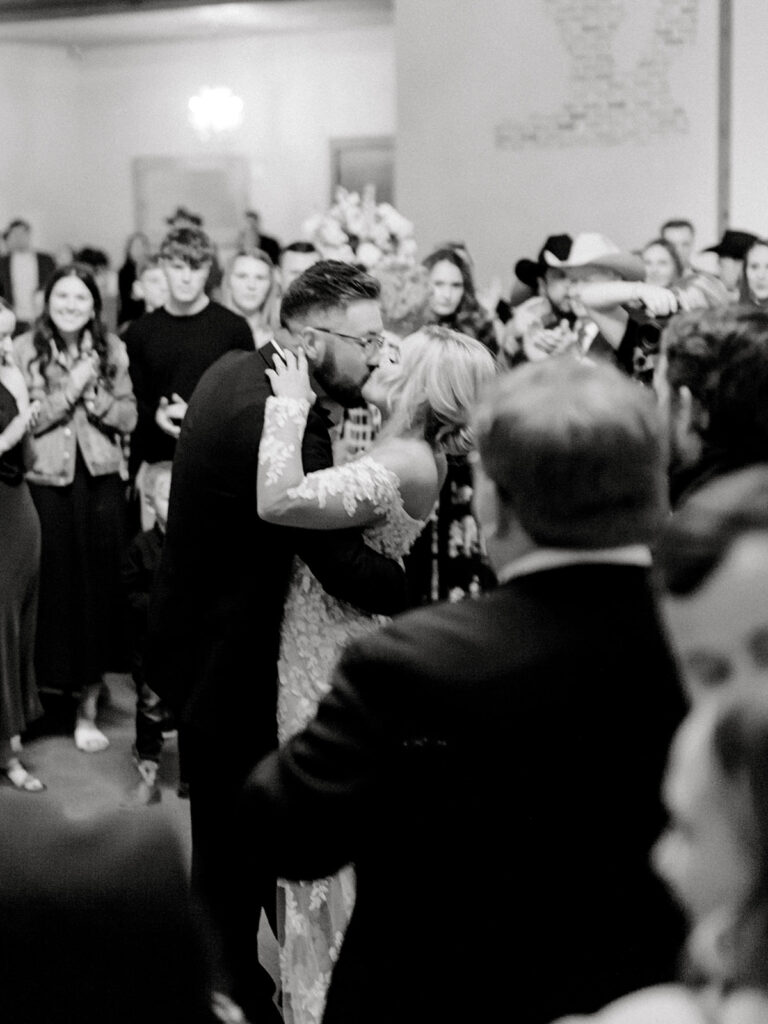 bride and groom kissing  | Chandelier of Gruene Wedding | Modern Black and White Chic Wedding | 