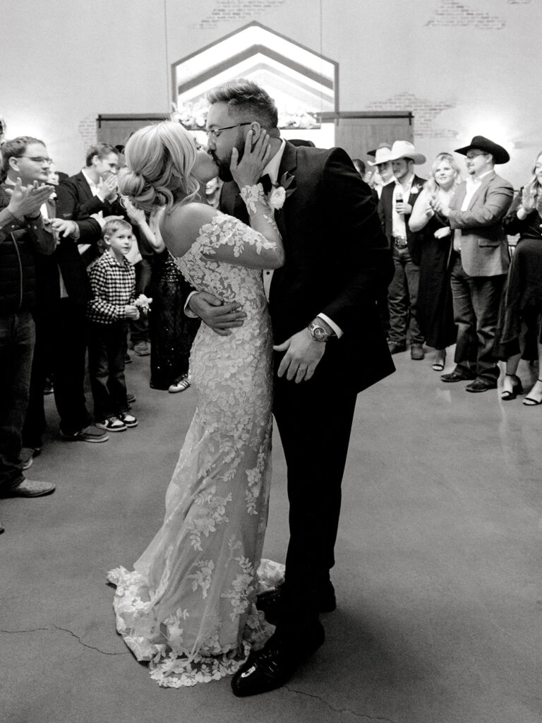 bride and groom kissing | Chandelier of Gruene Wedding | Modern Black and White Chic Wedding | 