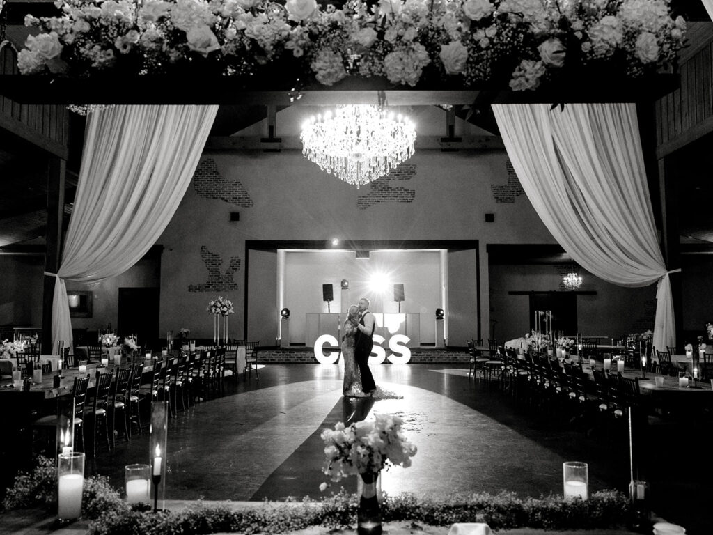 bride and groom full room shot  | Chandelier of Gruene Wedding | Modern Black and White Chic Wedding | 