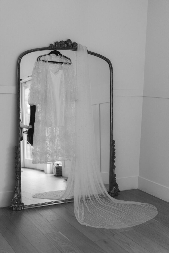 brides veil hanging on mirror in bridal suite
