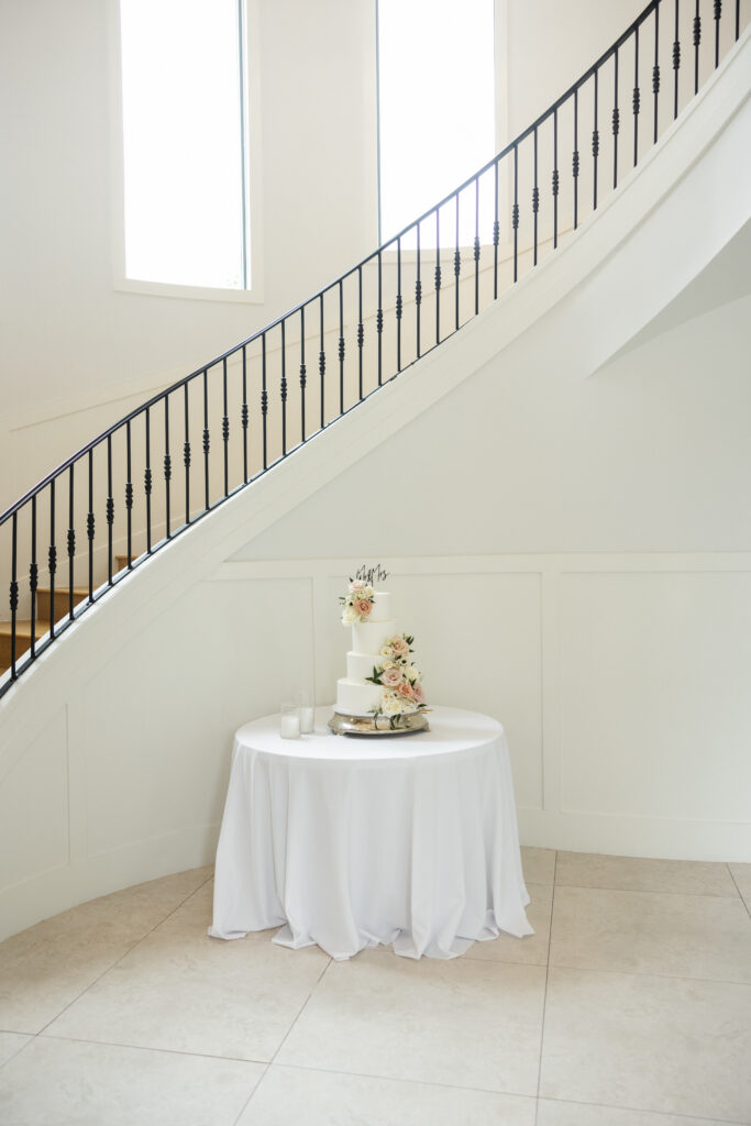 wedding cake next to stairs
