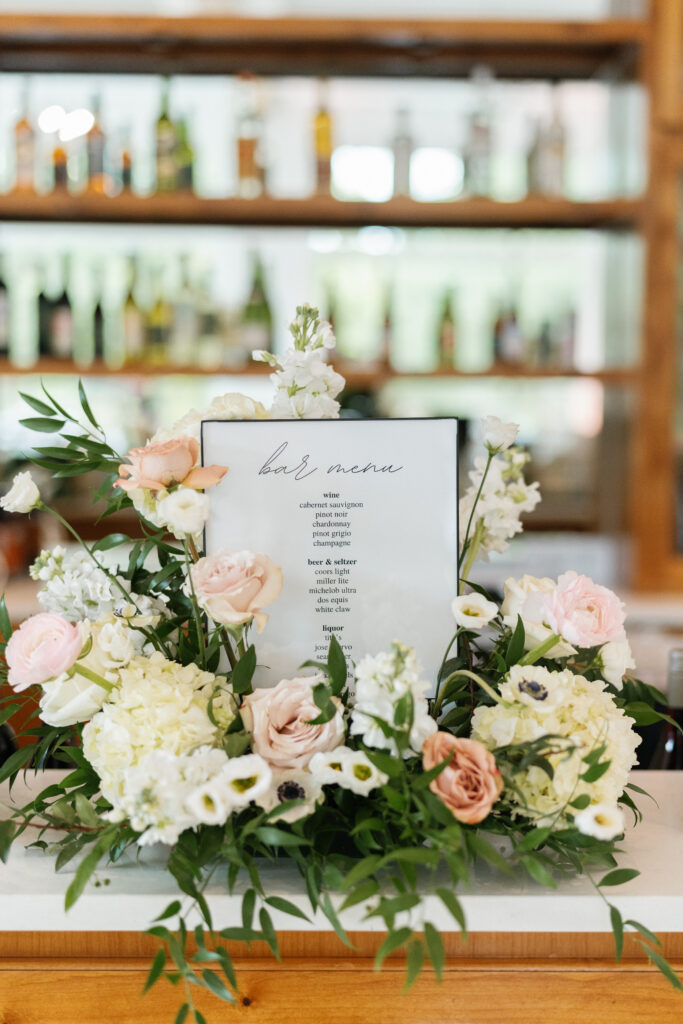 bar menu sign with flowers around