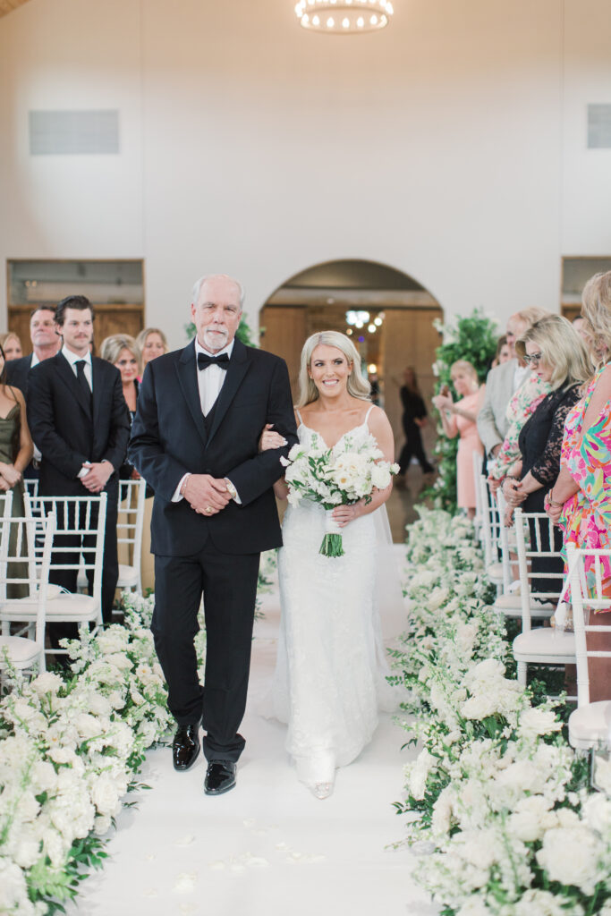 bride walking down floral aisle
floral filled wedding