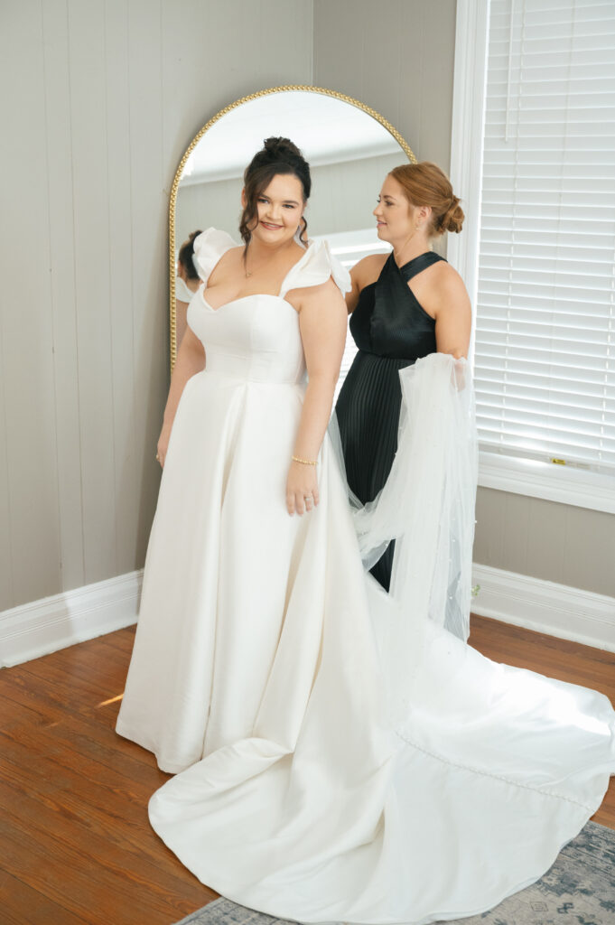 getting dressed bride and sister