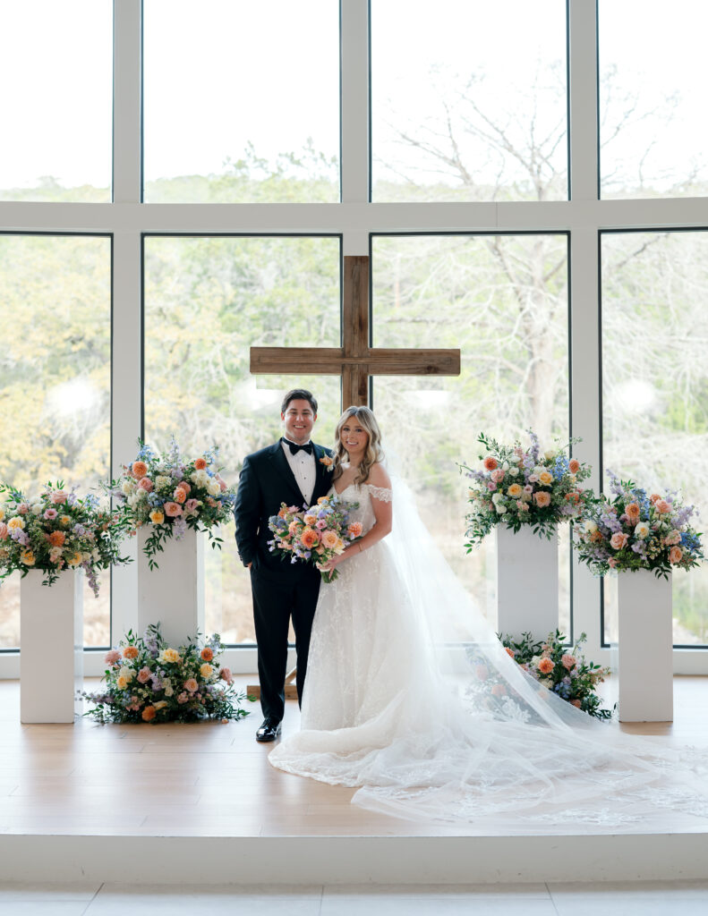 Floor to ceiling wedding chapel at The Preserve at Canyon Lake surrounded by soft pastel blooms 