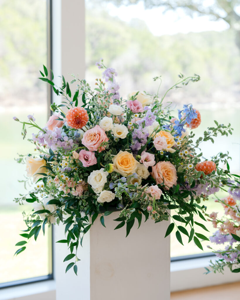 Floor to ceiling wedding chapel at The Preserve at Canyon Lake surrounded by soft pastel blooms 
