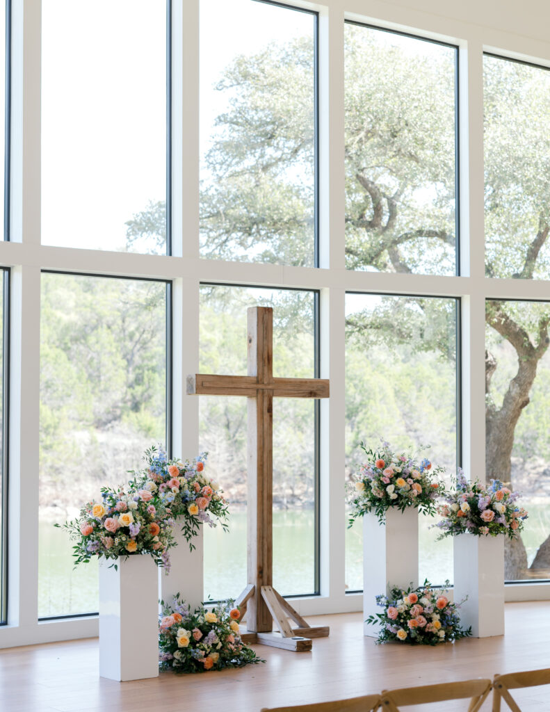 Floor to ceiling wedding chapel at The Preserve at Canyon Lake surrounded by soft pastel blooms