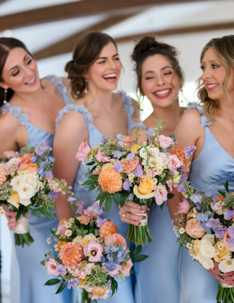 Bridesmaids laughing and holding pastel bouquets with peach, lavender, and blush blooms.
The Preserve at Canyon Lake wedding
