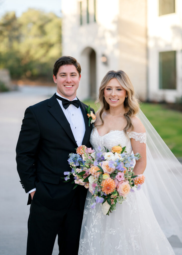 Bride and Groom with peach, lavender, and blush blooms