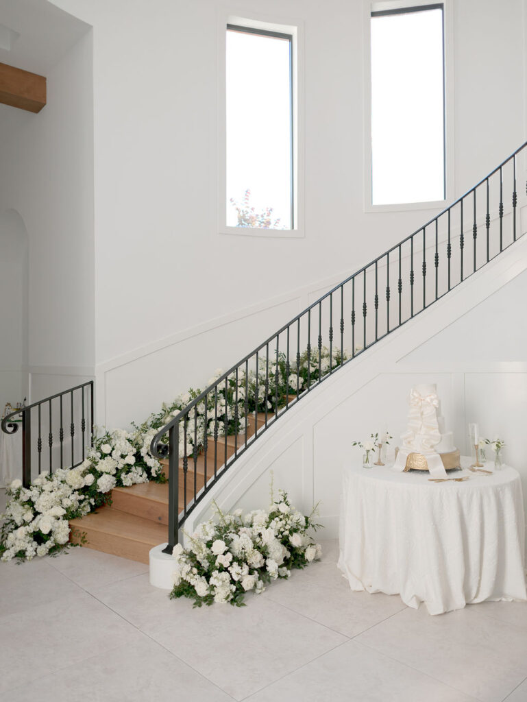 Repurposed aisle wedding day flowers lined the staircase perfectly