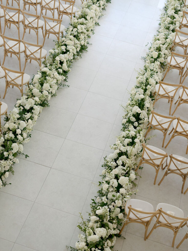 We created over 100 feet of white wedding aisle flowers for this event