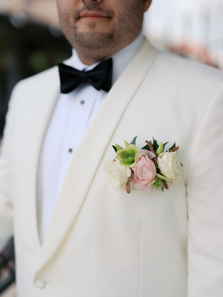 Floral pocket square style boutonniere for groom