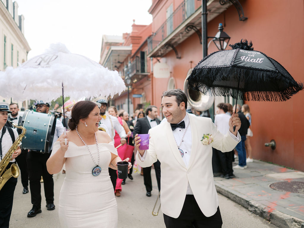 Newlyweds enjoying their second line in downtown New Orleans