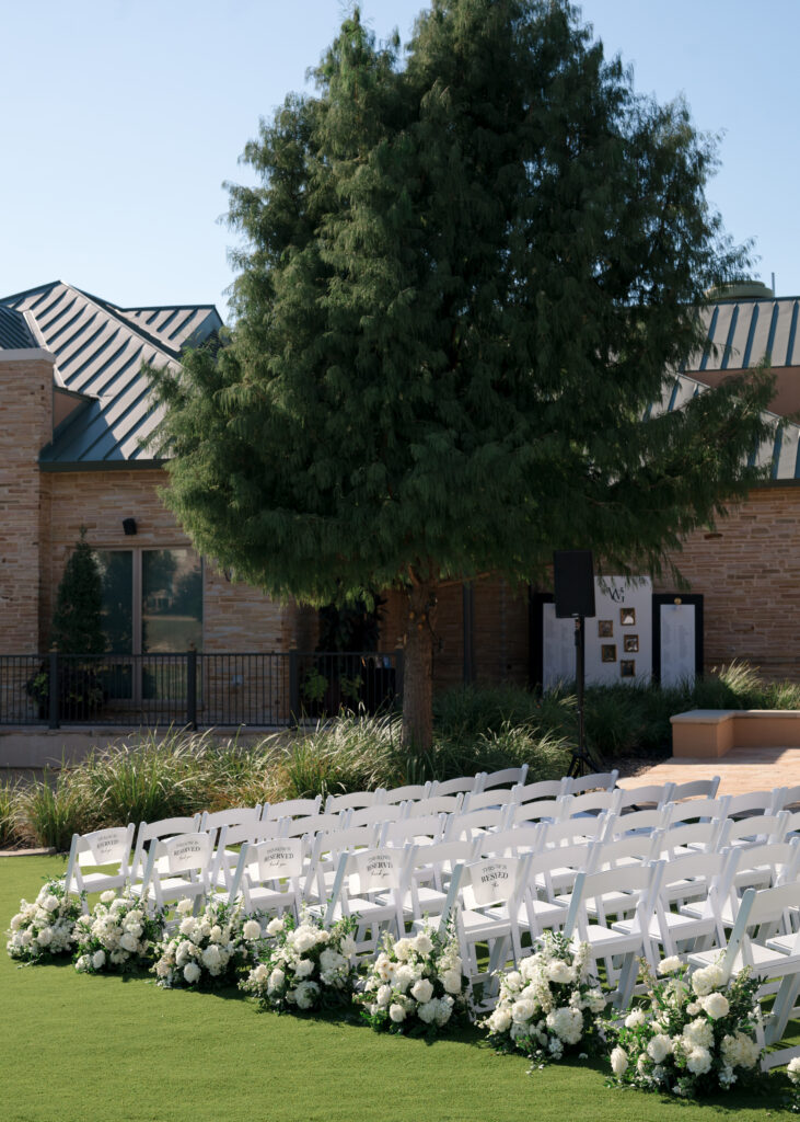 White grounded ceremony aisle florals