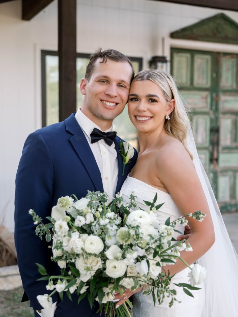 Newlyweds with white bridal bouquet