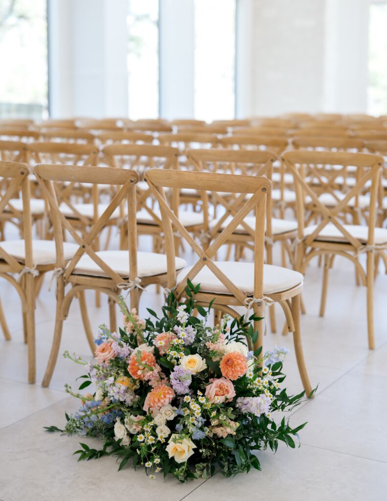 Aisle florals at indoor ceremony